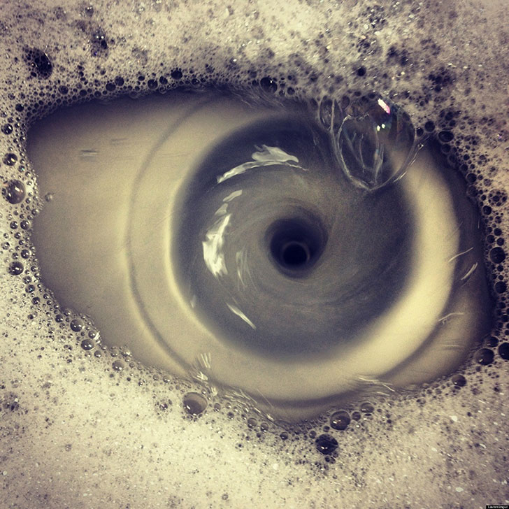 A sink draining that looks like an eye.